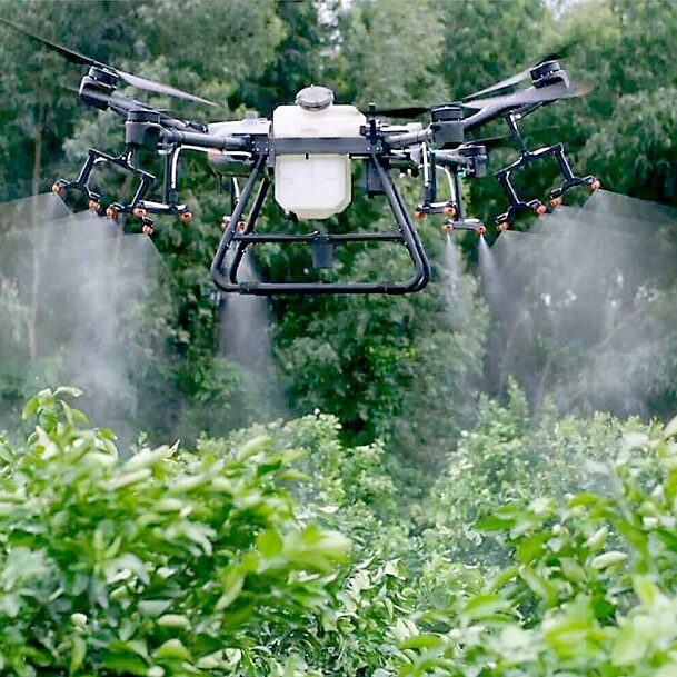 The DJI AGRAS T30 drone, made by a Chinese manufacturer, holds nearly 8 gallons of liquid and can fly for 10 to 15 minutes before being recharged. The large drone, seen here spraying water as a demonstration, can be modified to spray tree fruit orchards. (Courtesy Aerial Ag Technologies)